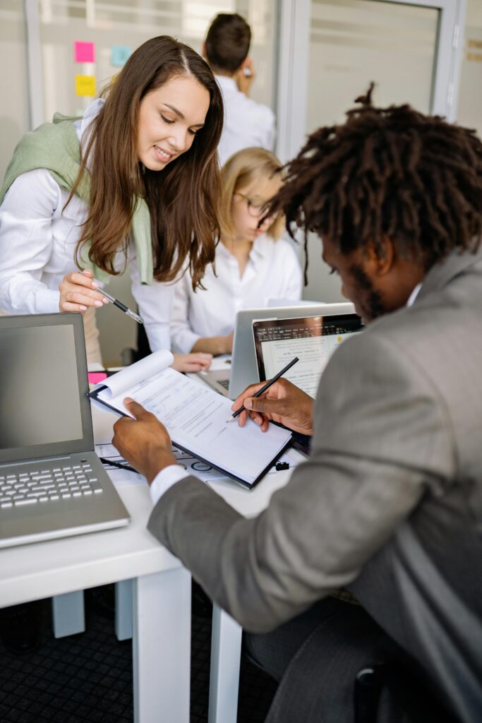 Diverse team working together in an office, sharing ideas and technology for effective collaboration.