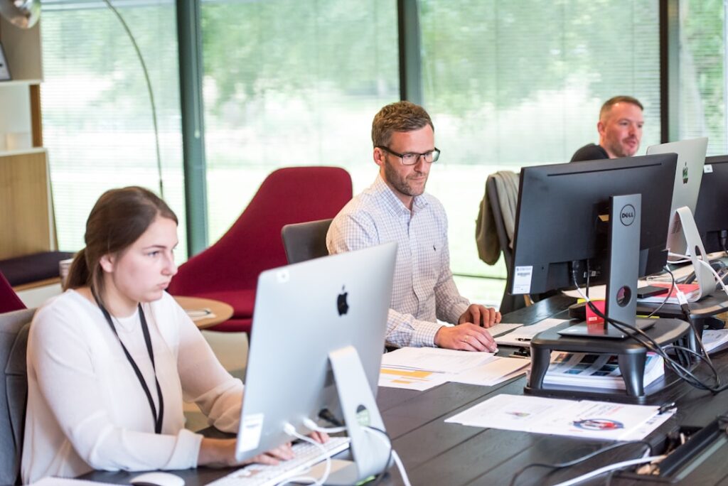 Customer service professional at a desk representing AI receptionist cost