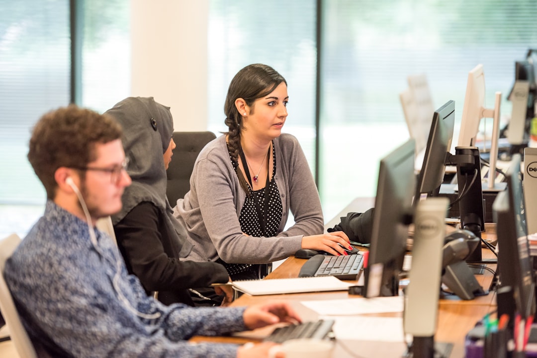 Office computer users representing AI chatbot versus AI phone receptionist