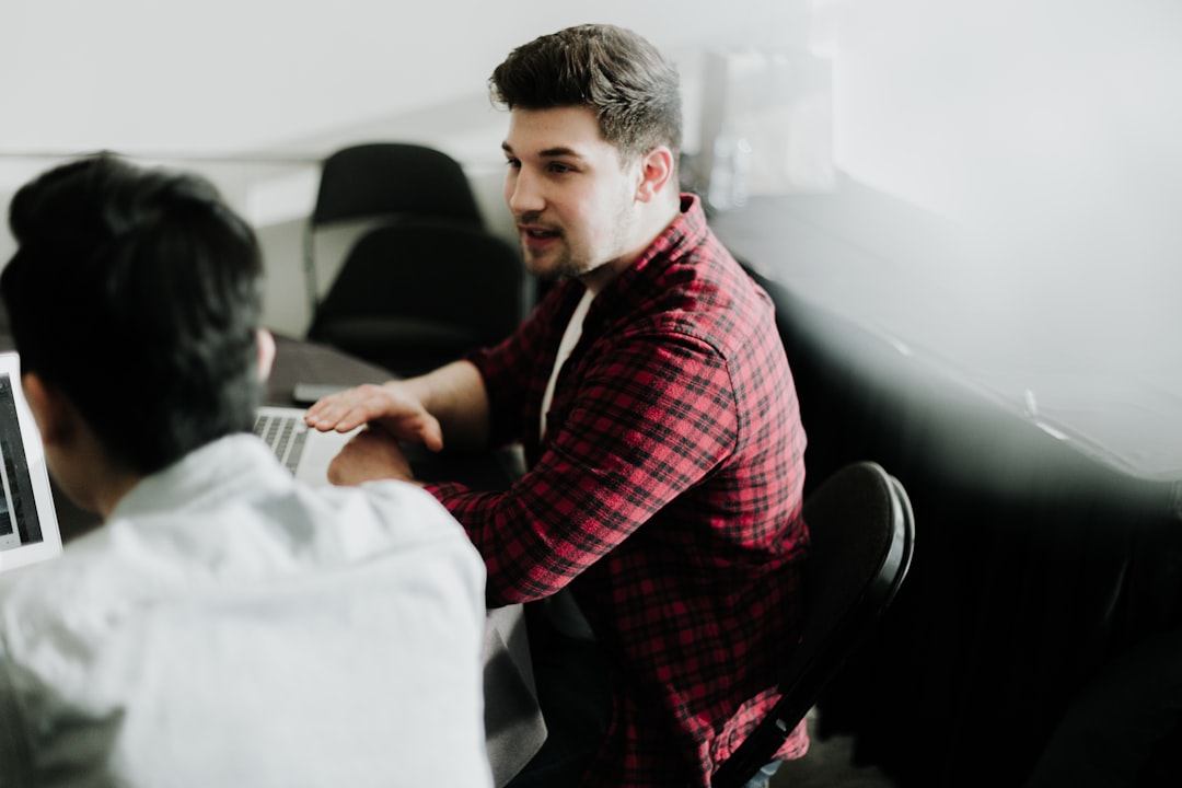 Business professional using a laptop representing digital marketing agency versus DIY decision making