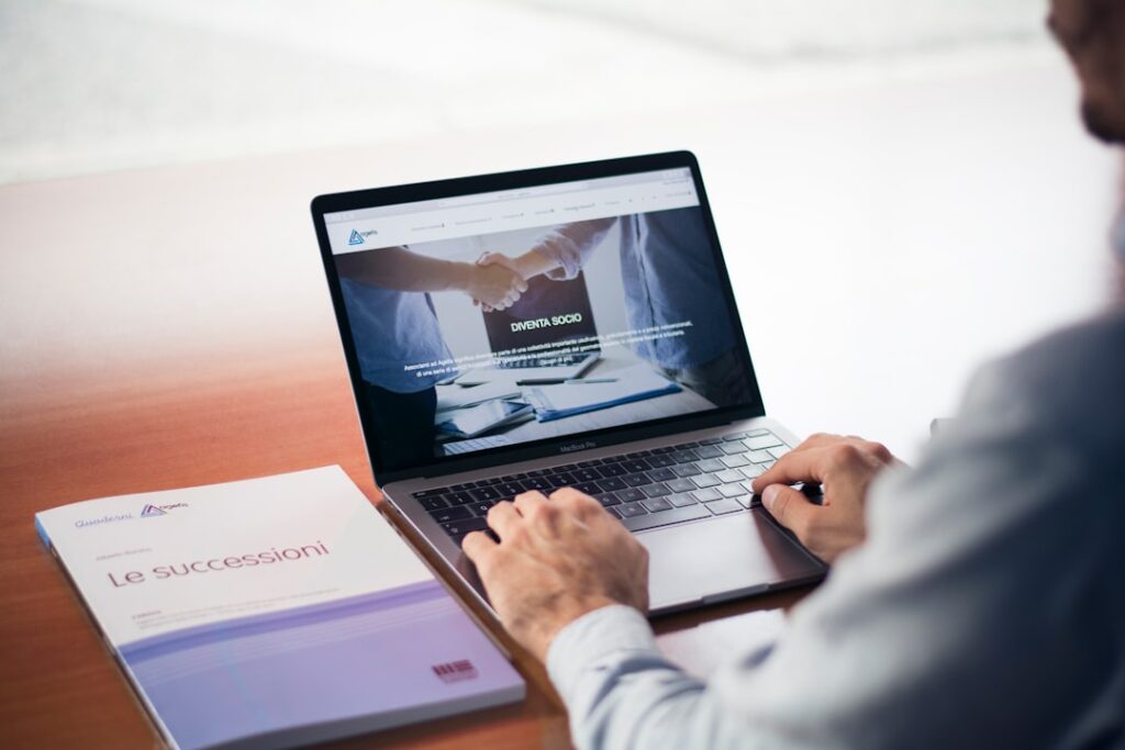 Business professional using a laptop representing WordPress and AI website builder comparison